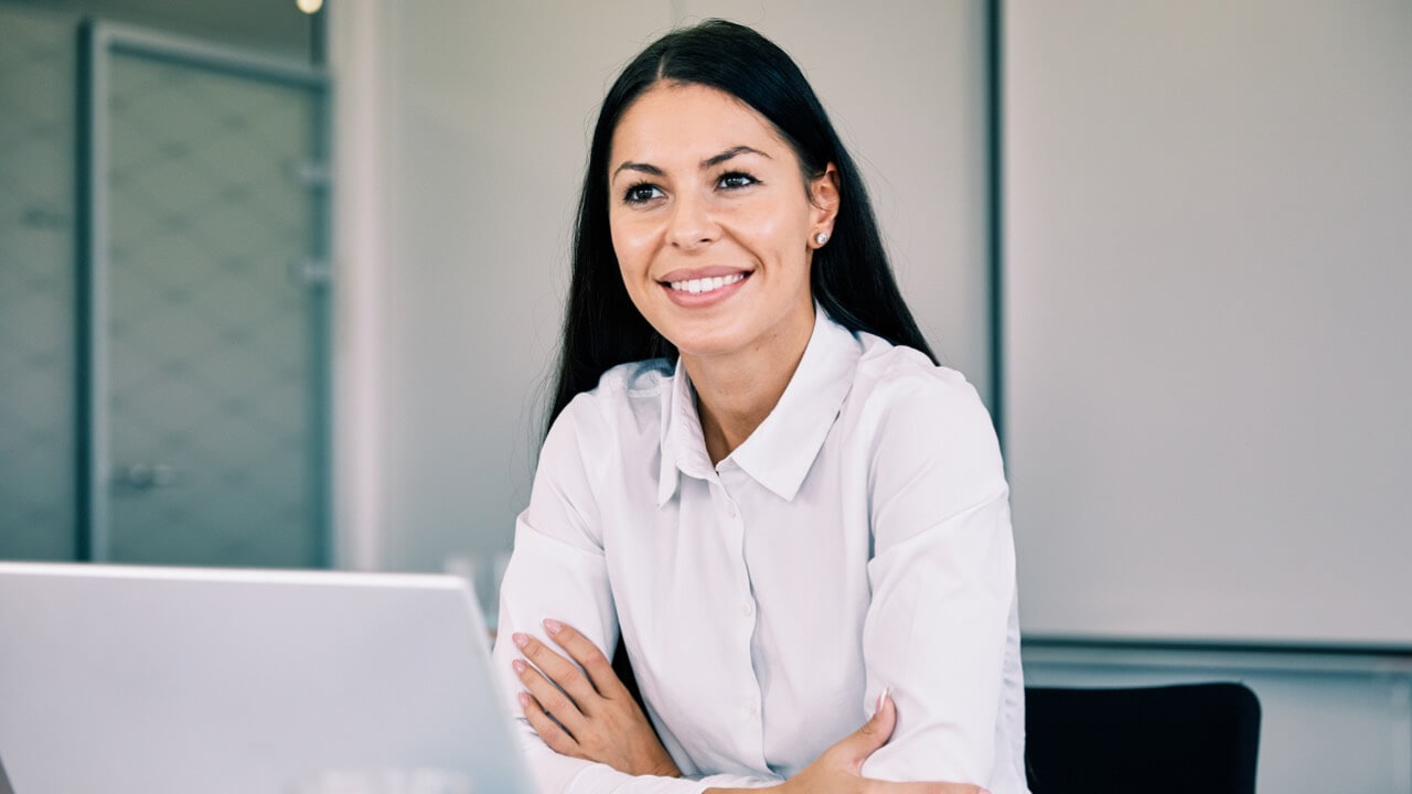 Smart woman smiling at desk