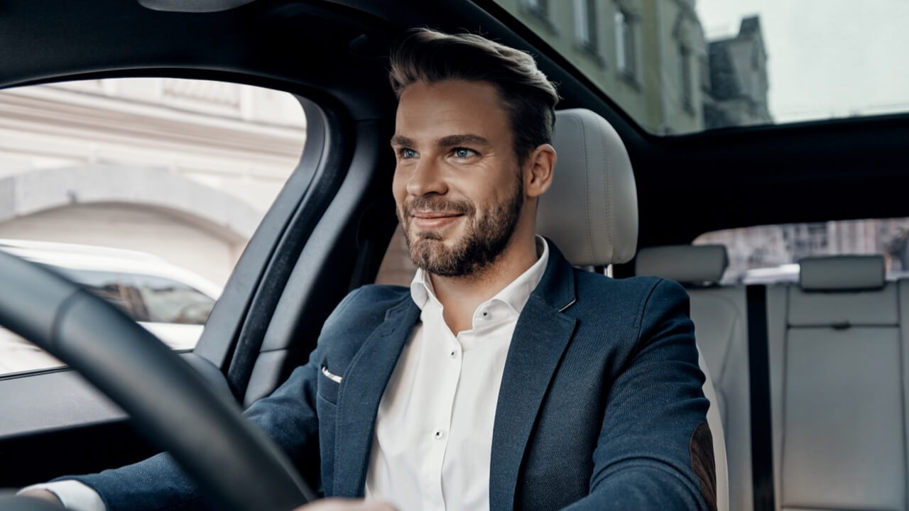 Smartly dressed man driving car