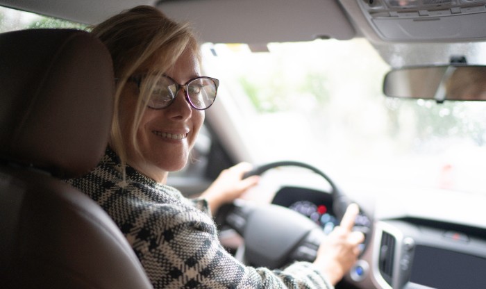 Female driving looking back and smiling