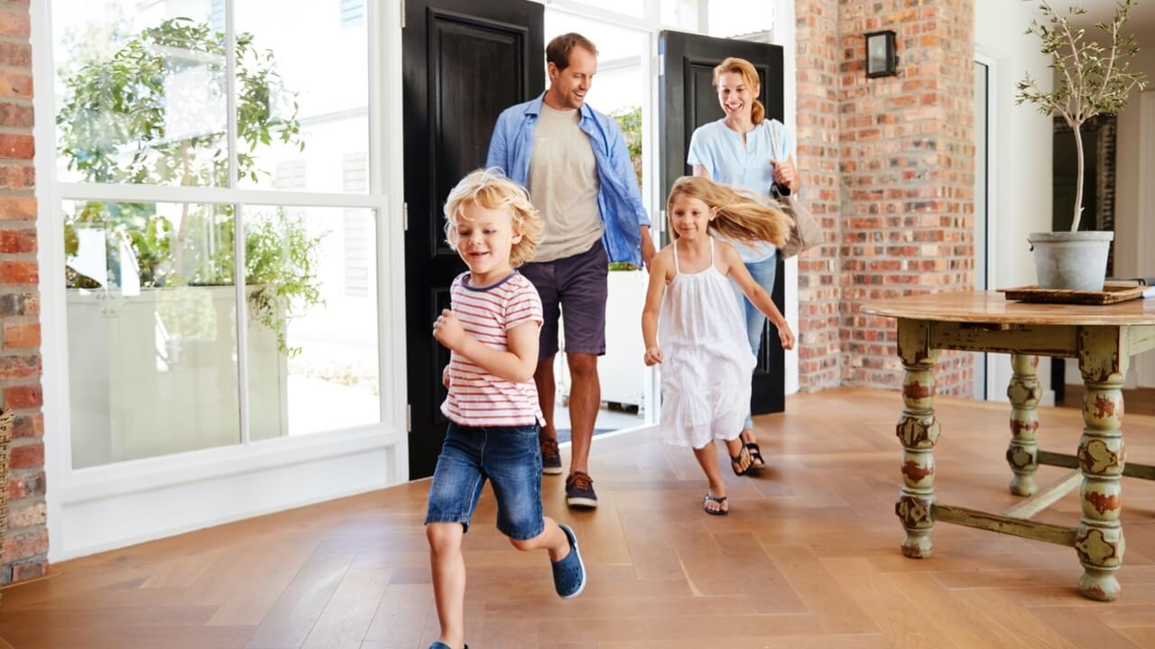 Young family walking into home