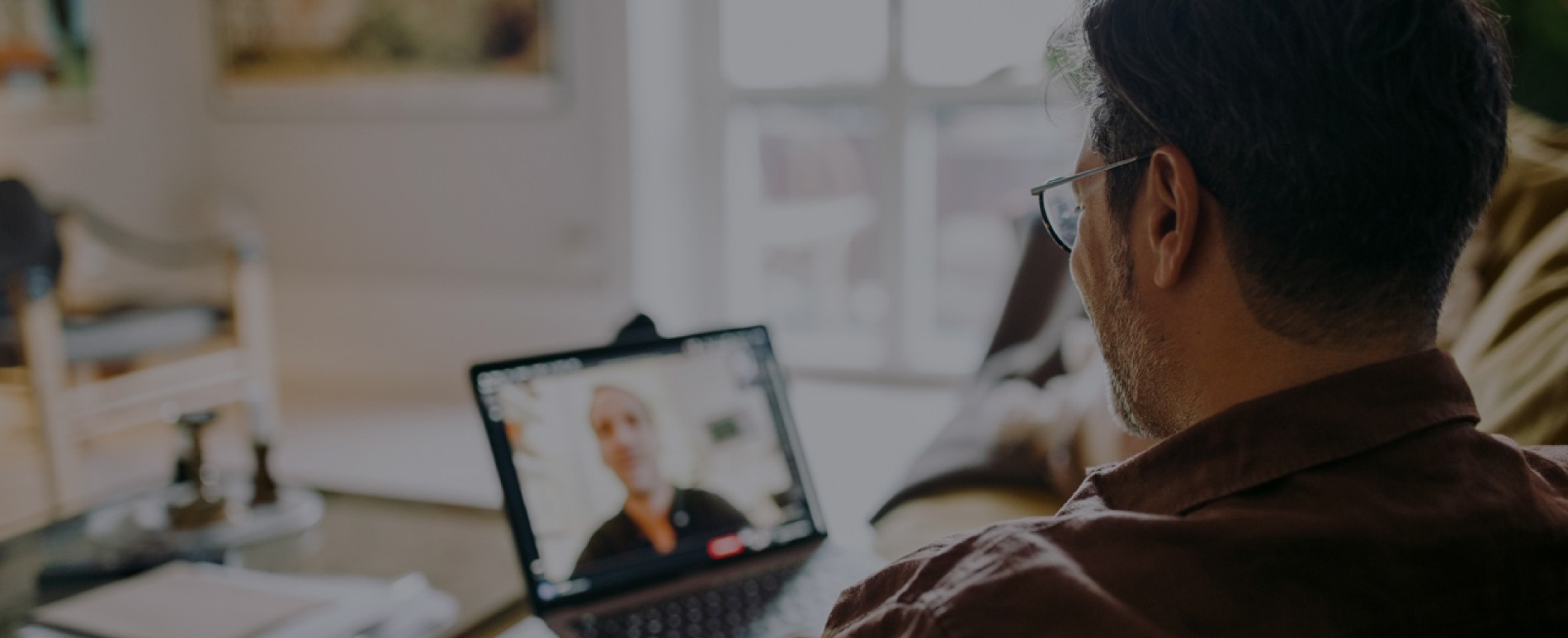 Mature man watching video on laptop