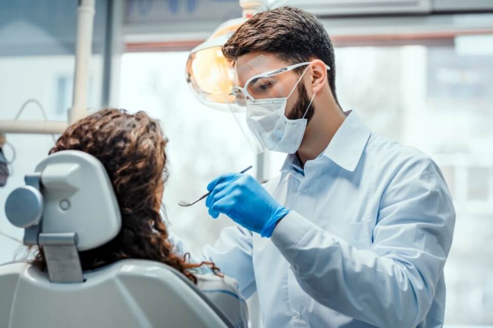 Male dentist with patient