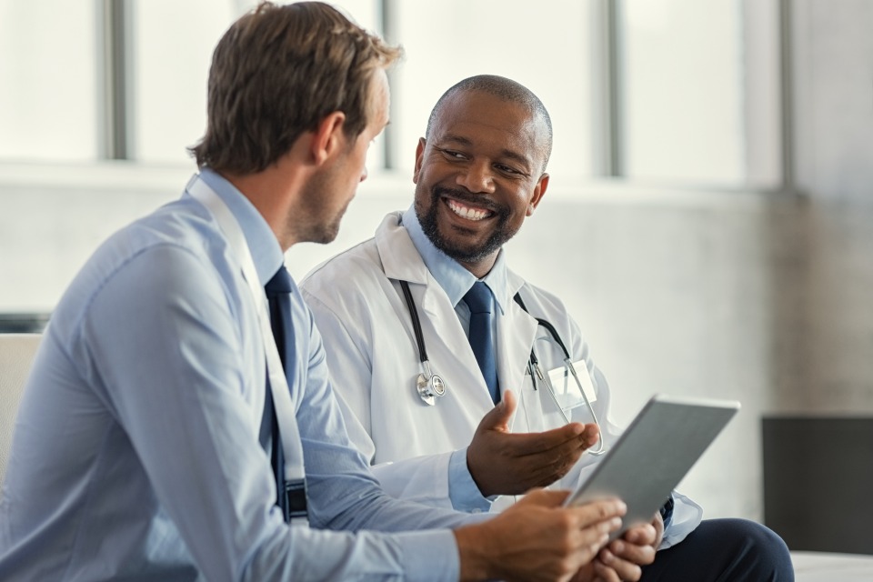 Two male medical professionals having a conversation