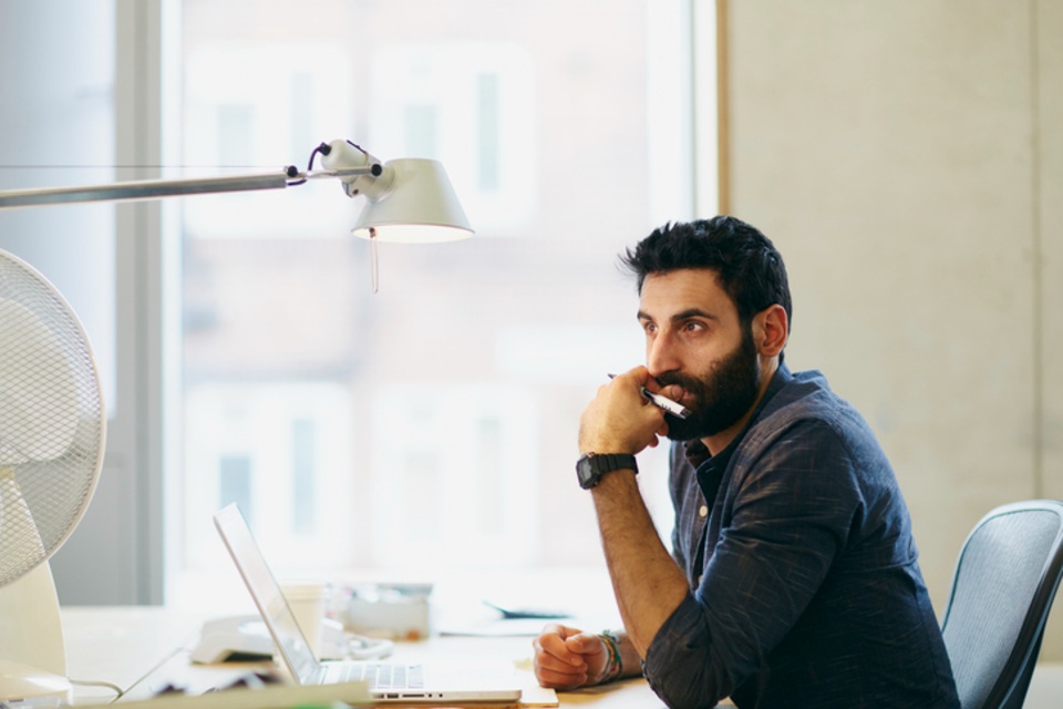 Professional male sitting at office desk