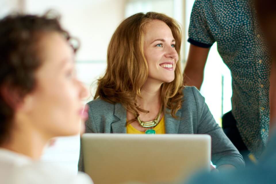 Woman in meeting with laptop