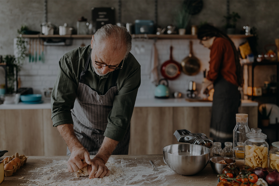 Mature couple cooking together in modern kitchen