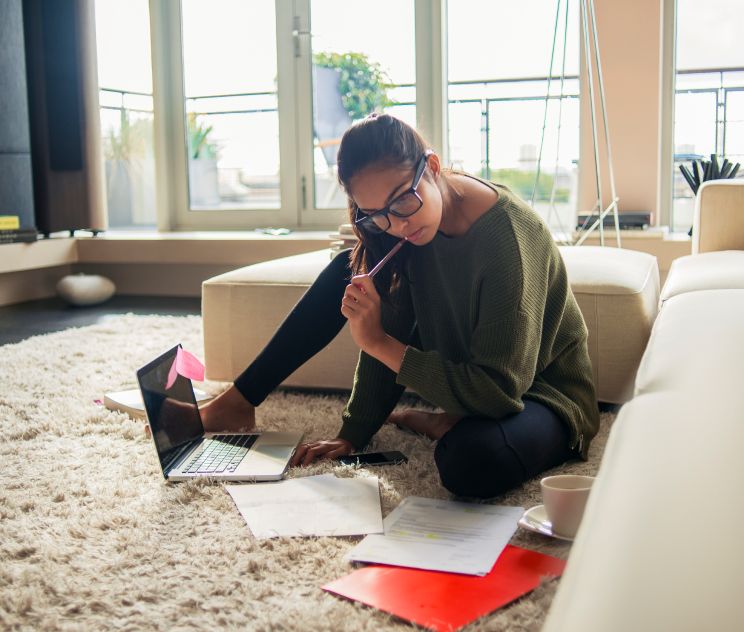 Female looking at papers in her home