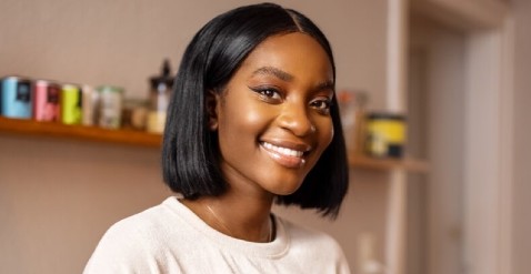 Young woman in kitchen smiling