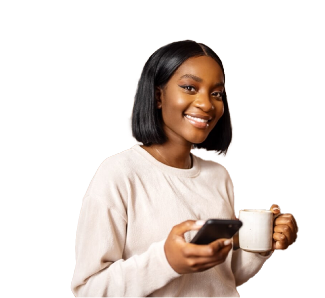 Female smiling who is holding a phone and mug